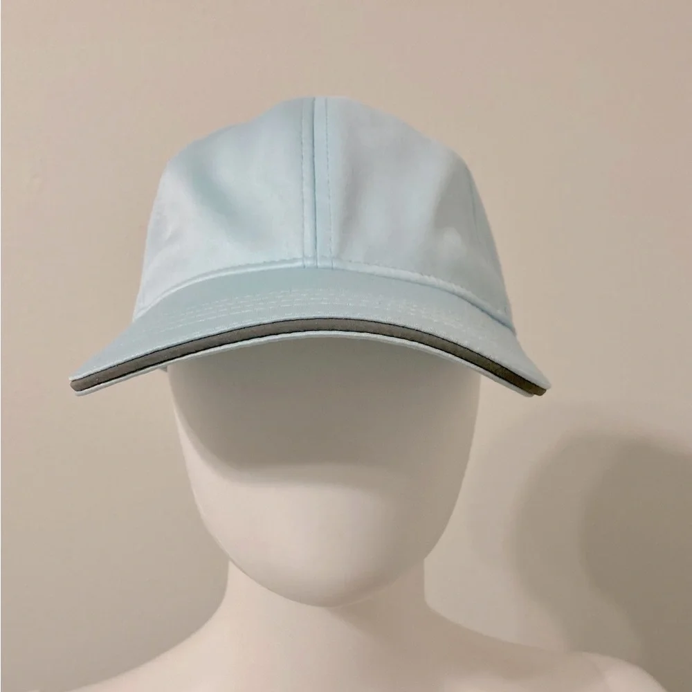 light blue baseball cap with reflective stripe on the peak self-adjusting .